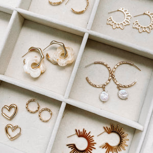 Various pairs of hoop earrings in jewelry display